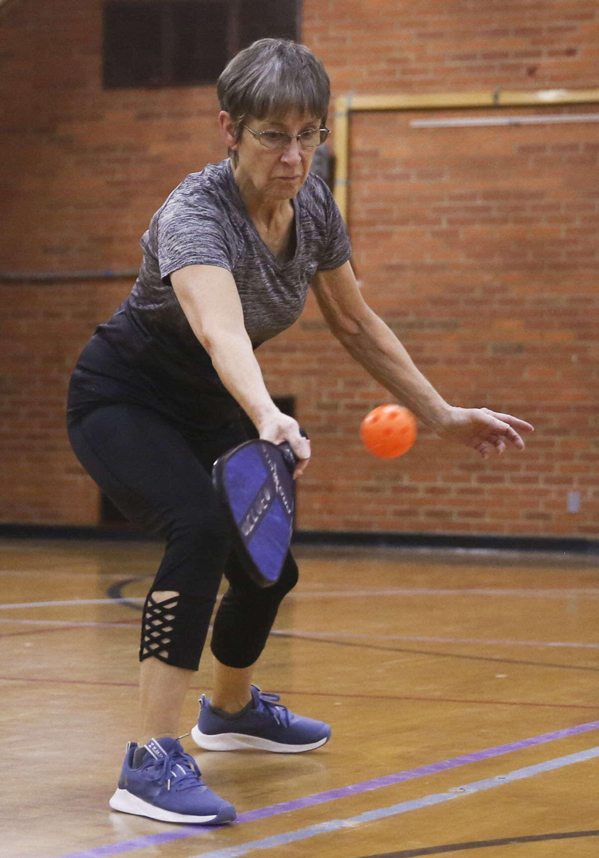 Joyce Gammon steps into the court as she returns the ball